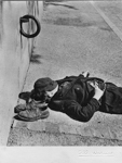 Photographie humaniste. Un clochard allongé sur les quais de Seine photographié par Monier  - Paris (75)  - 1935