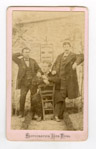 Photographie de trois hommes posant en extrieur devant une affiche de liqueur  - Soissons (2)  - 1865